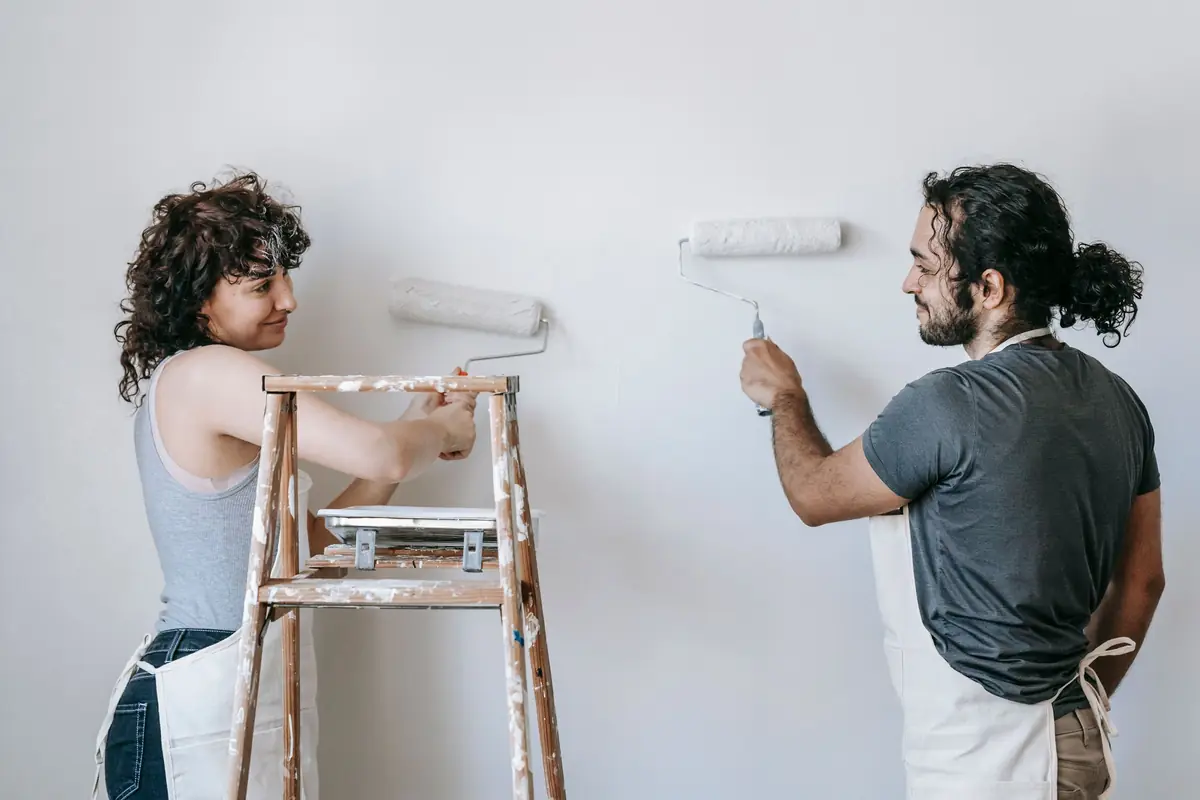 People painting a wall together — painting help in Boise